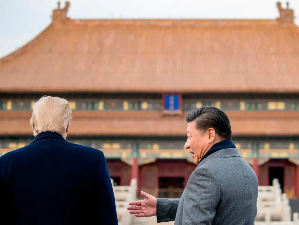 President Donald Trump and Chinese President Xi Jinping speak together as they tour the Forbidden City.