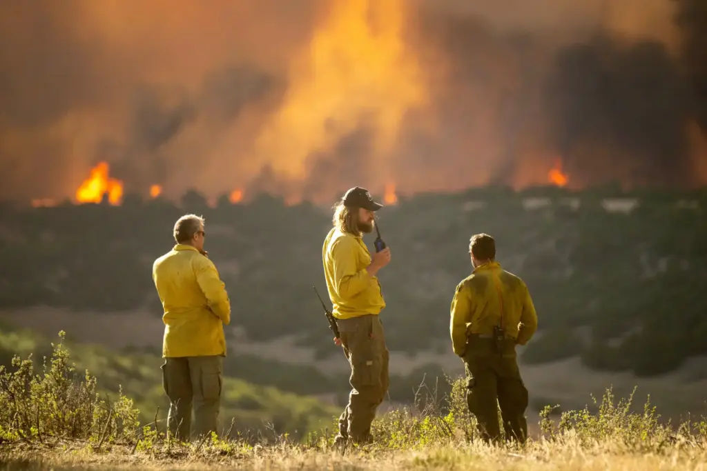 Firefighters monitor the Aspen Acres Fire near Colorado City, Colo.,...