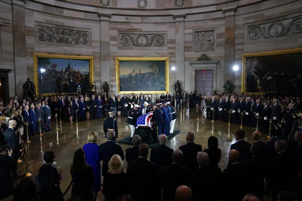 A team places the flag-draped casket of Sen. Lindsey Graham in the Capitol Rotunda.