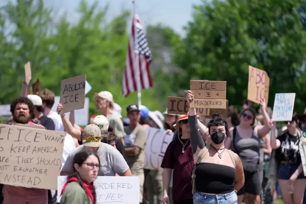 Protesters gather near the scene of a shooting involving U.S....