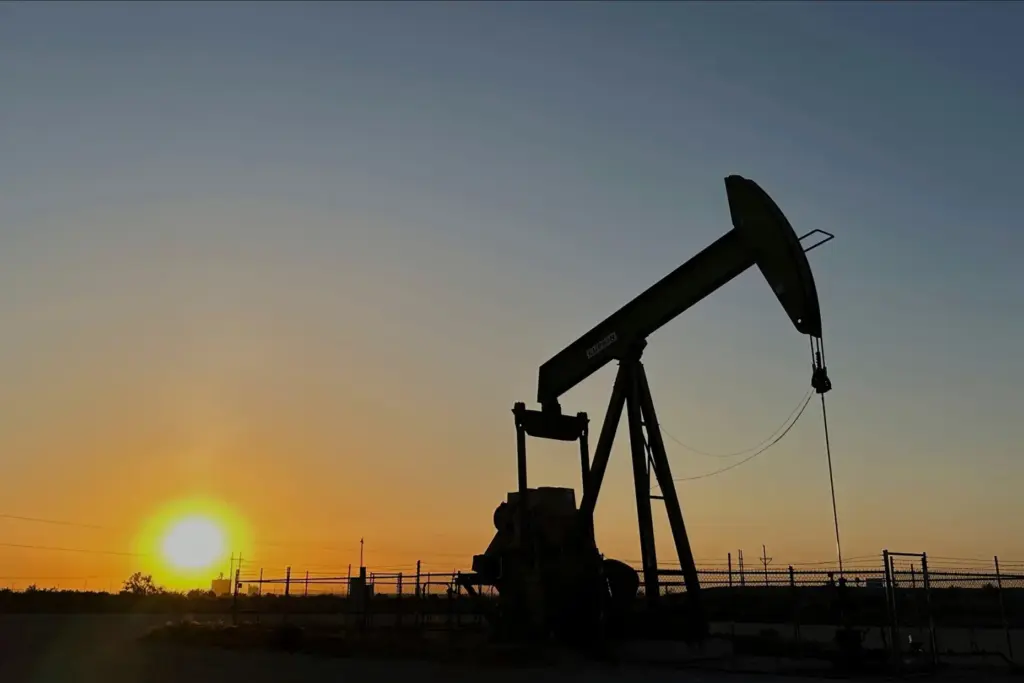 The sun sets as a pump jack operates near Loving, New Mexico.
