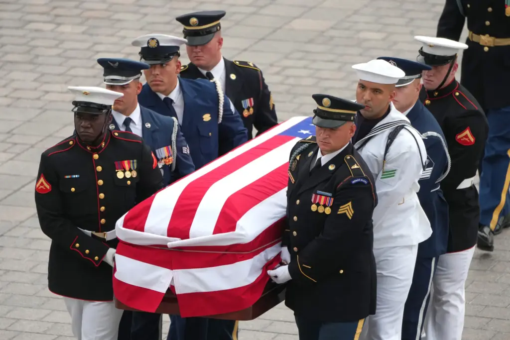 An Armed Forces Body Bearer Team moves the casket of Sen. Lindsey Graham.