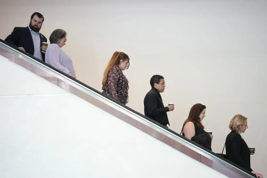Members of the Hortman family come down the escalator into...