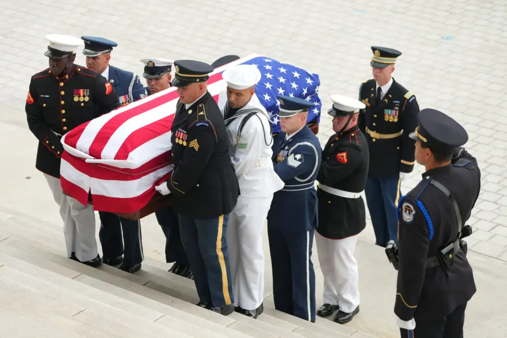 An Armed Forces Body Bearer Team moves the casket of Sen. Lindsey Graham.