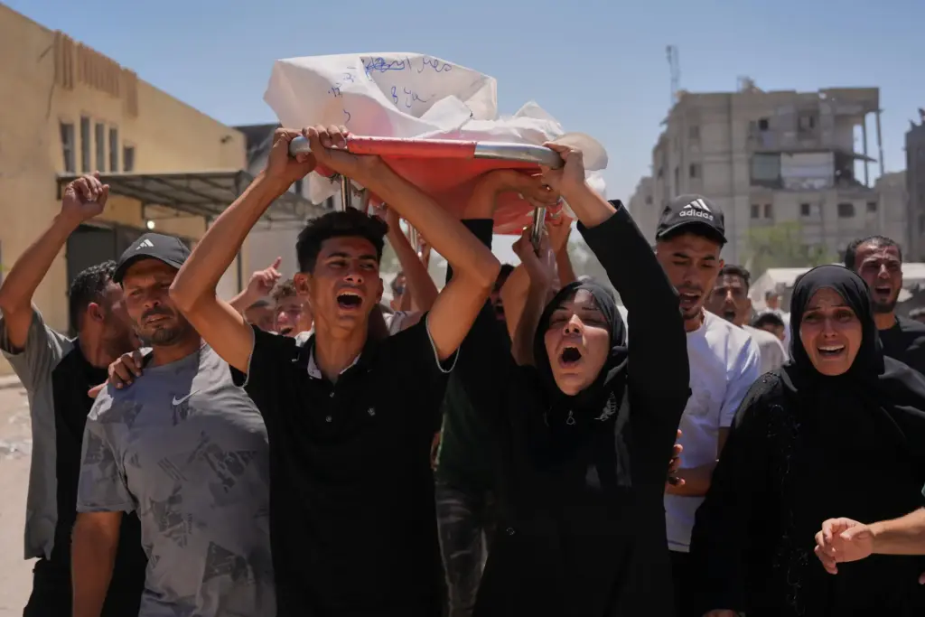 Warda Abu Shaar carries the body of her 10-year-old son, Motaz Abu Shaar.