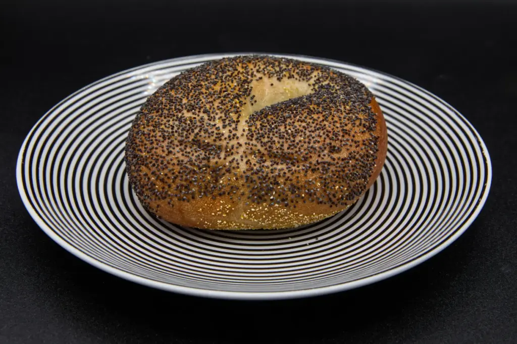 A poppy seed bagel on a plate photographed in Phoenix,...