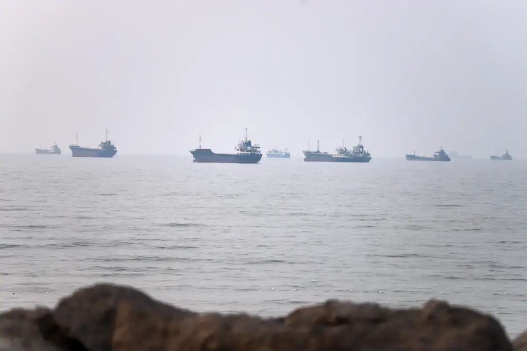 Commercial vessels are seen in the Strait of Hormuz off...