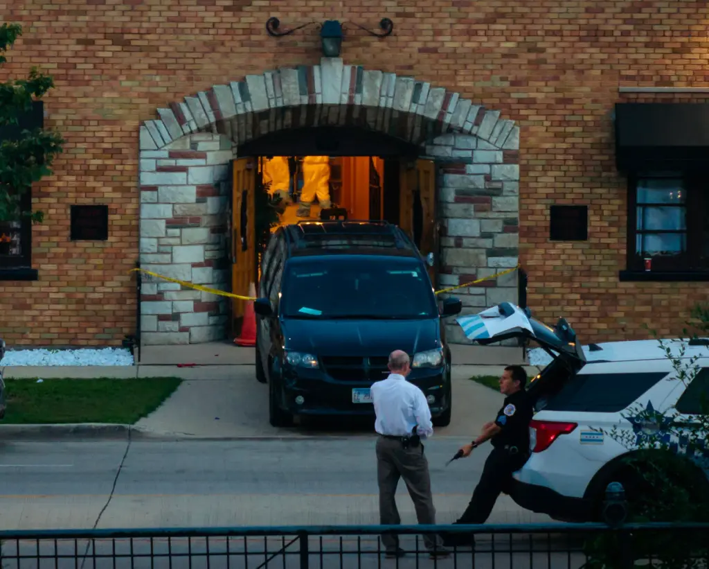 People in hazmat suits work inside the South Chicago Chapel...