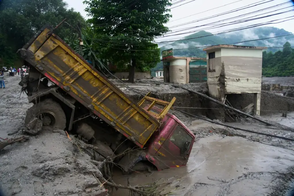 A vehicle is seen in the aftermath of a flash...