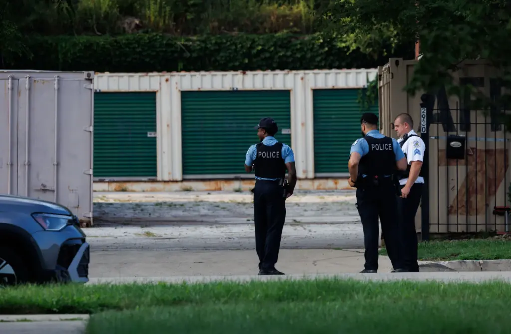 Chicago police officers work the scene where dozens of bodies...