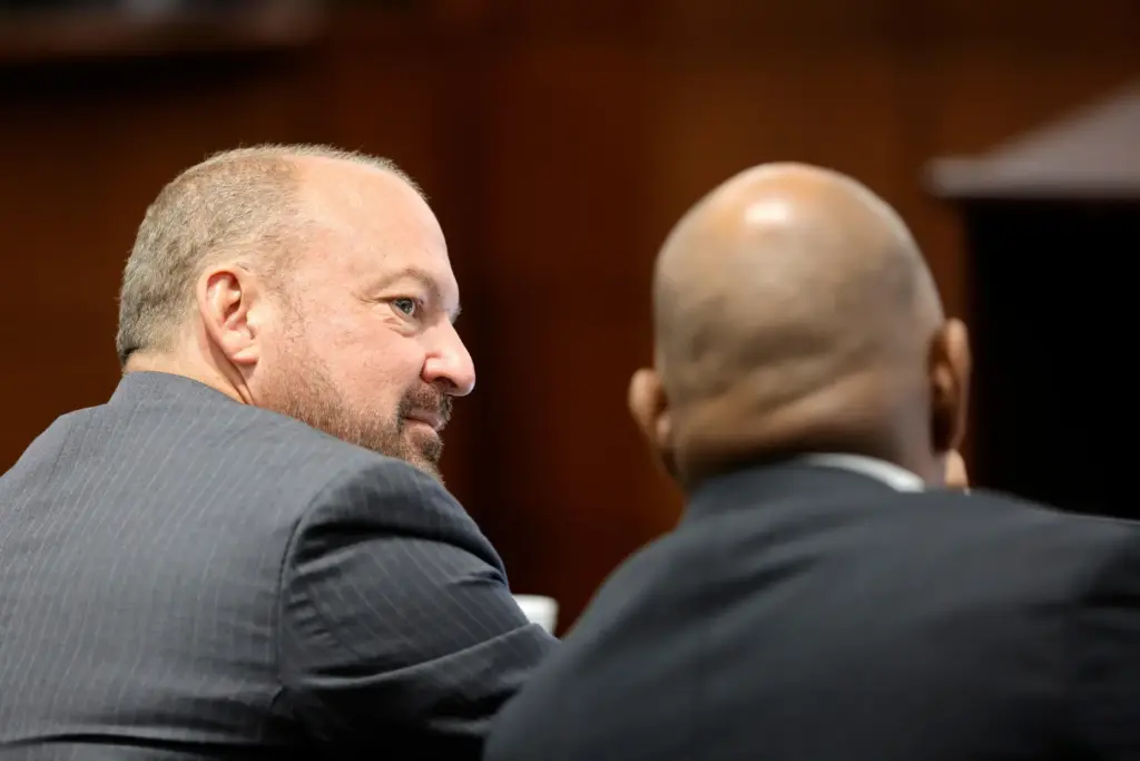 Chief Deputy District Attorneys Marc DiGiacomo and Binu Palal confer.