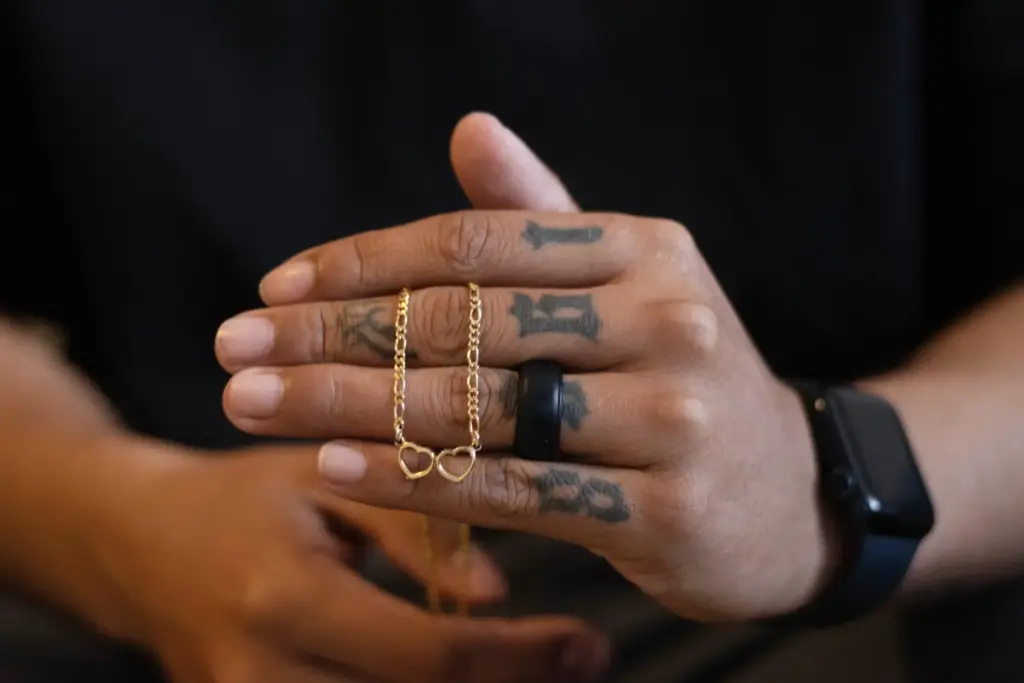 Army Sgt. Hedar Leonel Turcios Juarez holds a necklace he gave to his wife Cristy.