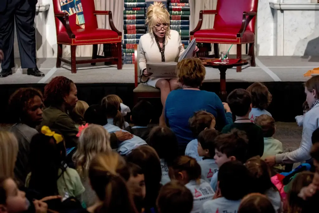FILE – Dolly Parton reads her book “Coat of Many...