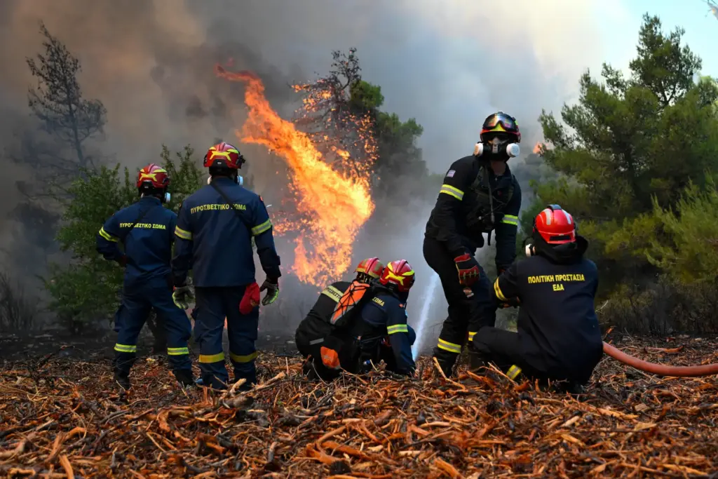 Firefighters operate during a wildfire near Porto Germeno, northwest of Athens, Greece.