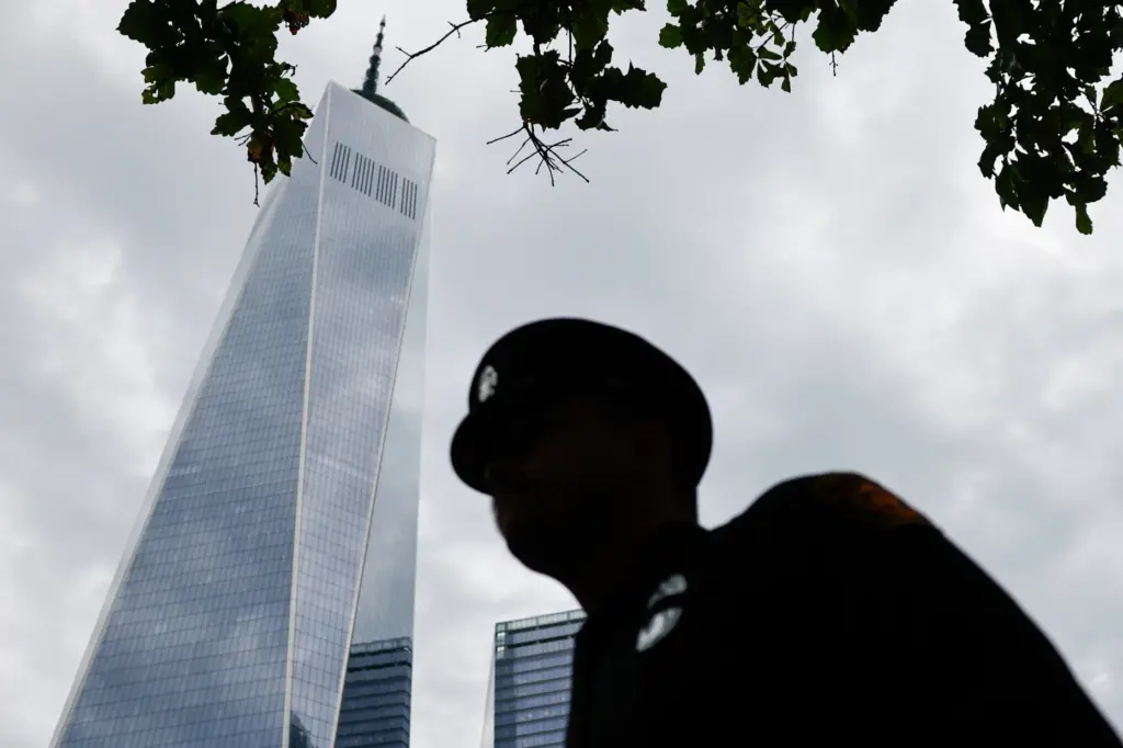 A law enforcement officer stands during a ceremony commemorating the 25th anniversary of 9/11.