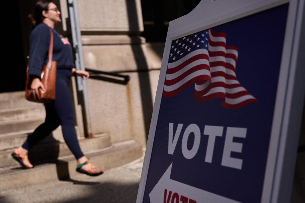 A sign directs voters to an entrance for City Hall during early voting in Providence, Rhode Island.