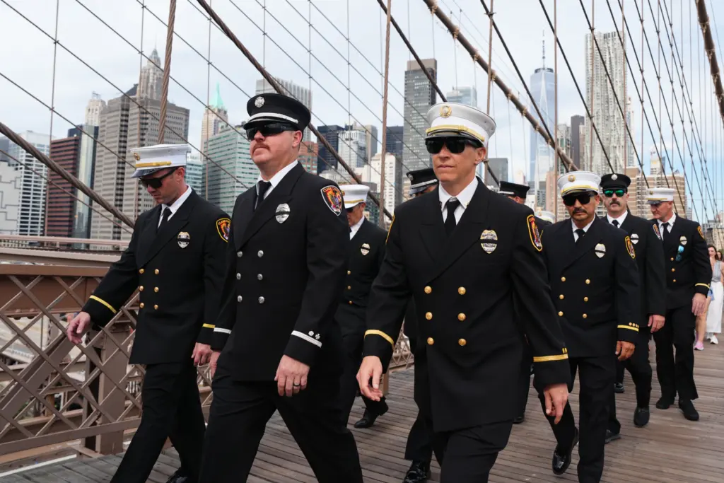 Firefighters walk across the Brooklyn Bridge on the 25th anniversary of 9/11.