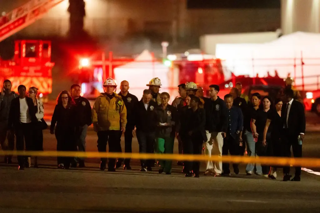 Los Angeles Mayor Karen Bass and other officials walk to a news conference.