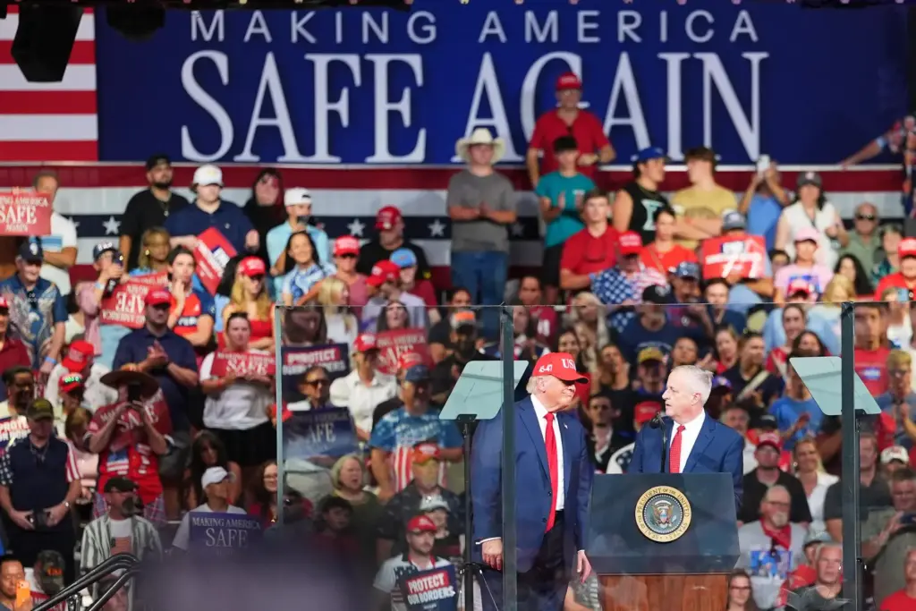 Michael Whatley, North Carolina senatorial candidate, and President Donald Trump speak during a campaign rally.