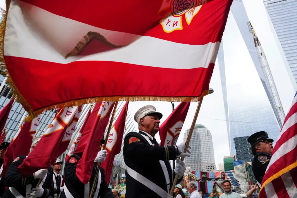 New York City firefighters march near the memorial on the...
