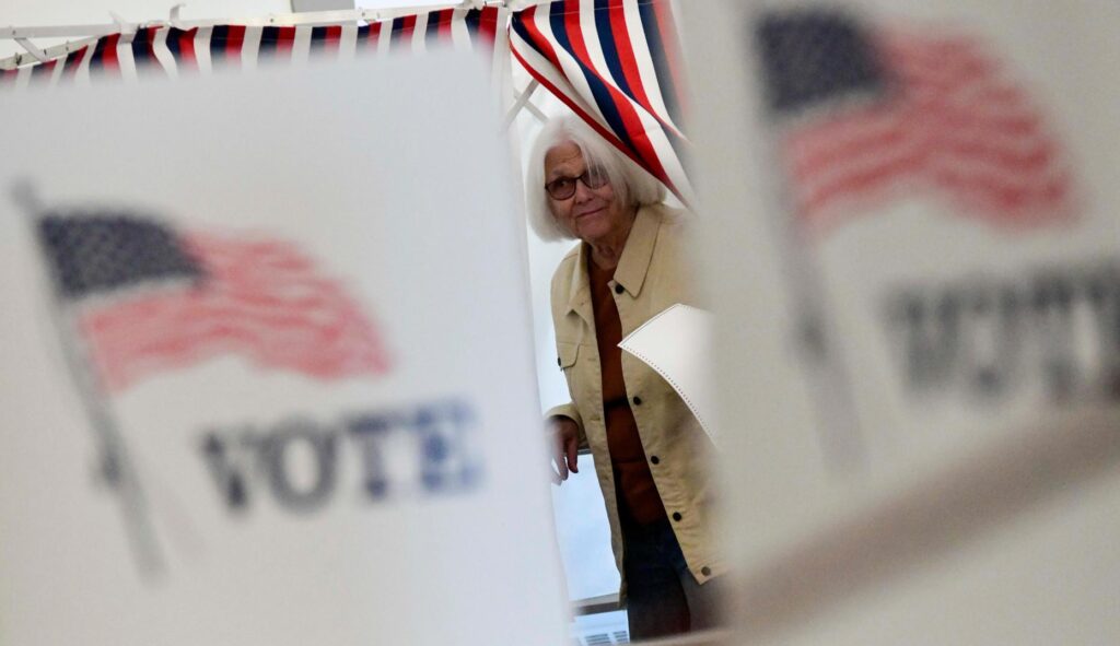 Peggy Jacobs of Chesterfield, N.H., leaves the voting booth.