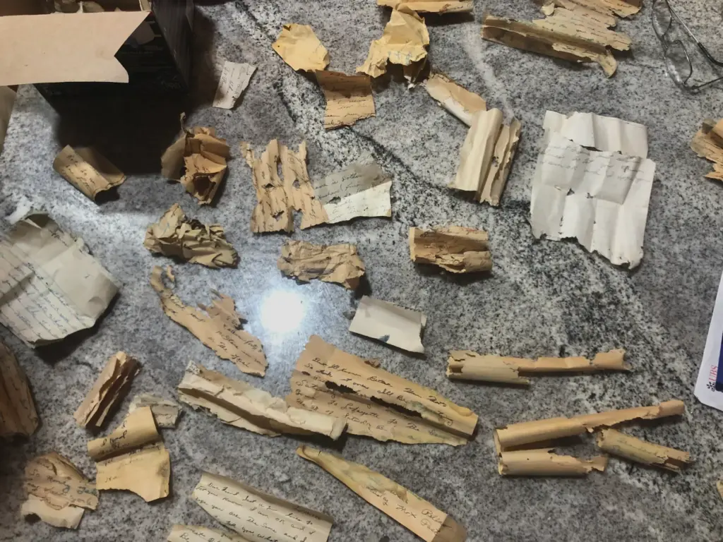 The remnants of old letters are laid out in the...