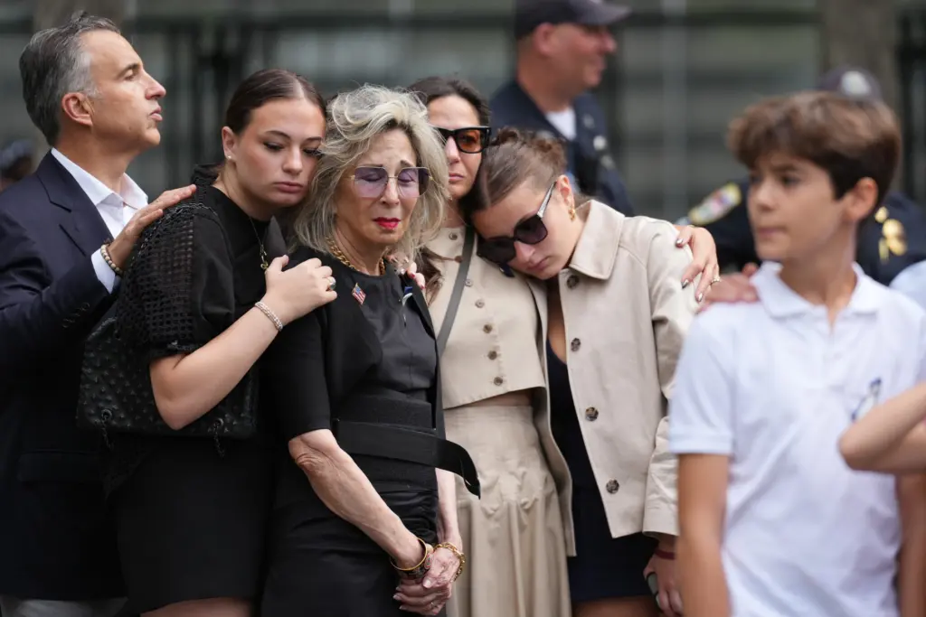 People listen to the U.S. national anthem at the memorial on the 25th anniversary of 9/11.