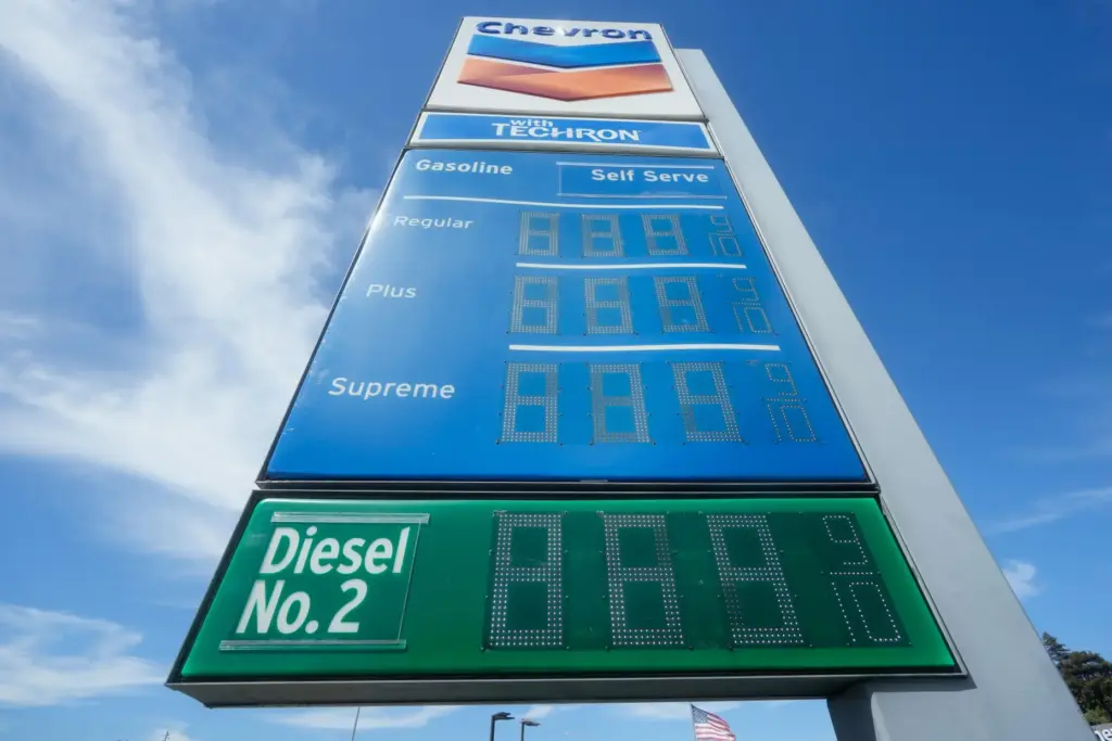 The cost of diesel is displayed on the bottom of a gasoline price board.