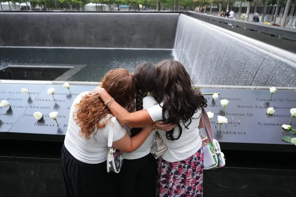 Rosanne Spirito and daughters Sabrina and Amanda stand at a reflecting pool.
