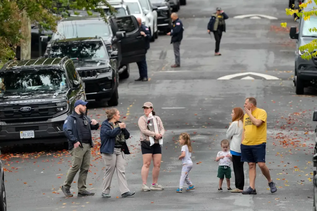 Homeland Security officers speak with residents during an investigation at the residence of Rep. Ilhan Omar.