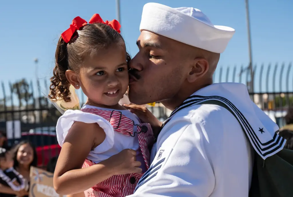 Coronado, CA – Sailor Tereance Stokes Jr. kisses his daughter...