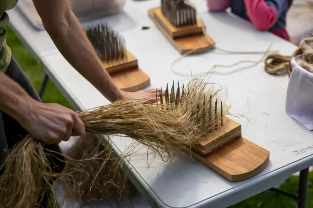 Melissa Duhaime hand-processes recently harvested flax straw on Sept. 22,...
