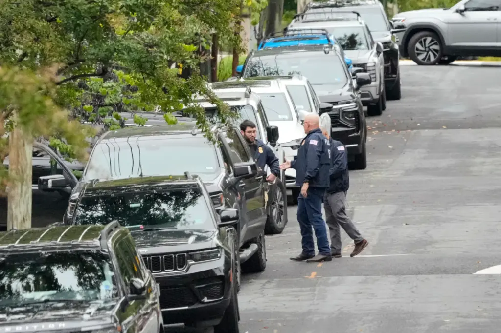 Homeland Security officers stand during an investigation at the residence of Rep. Ilhan Omar.