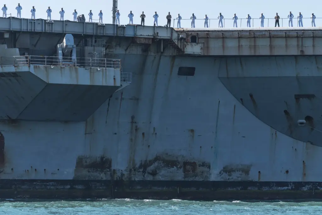 San Diego, CA – Sailors stand on top of the...