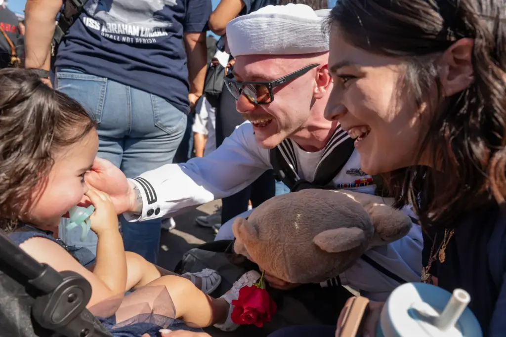 Coronado, CA – Sailor Trent McIsaac greets his daughter Luna,...