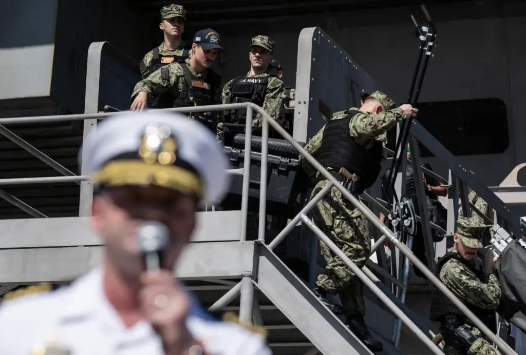 Coronado, CA – Sailors begin to offload gear as Navy...