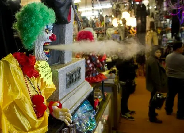 Smokey the Clown blows smoke as customers wait in line at Reinke Brothers in Littleton.<!--IPTC: